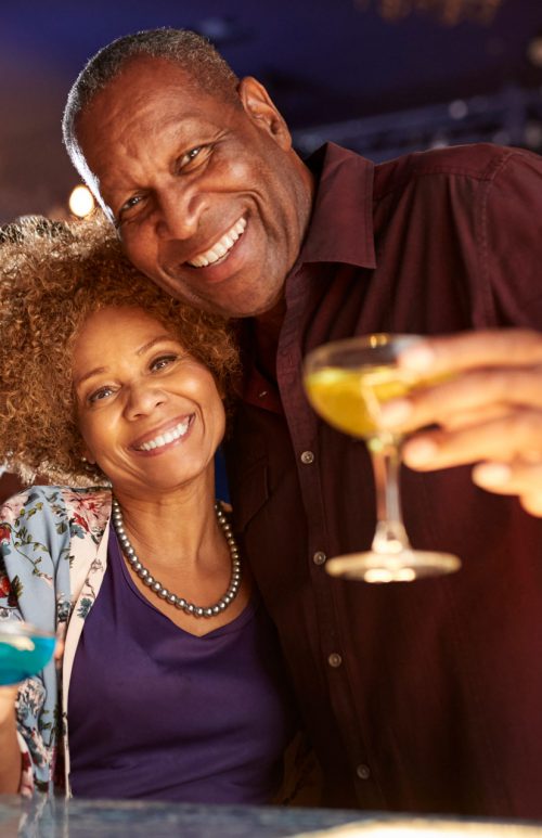 portrait-of-senior-couple-drinking-and-dancing